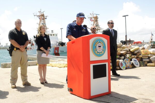 A US Coast Guard vessel interdicting a suspected drug-smuggling boat in the Caribbean Sea, representing the new security perimeter drawing Latin America into global conflict risk.