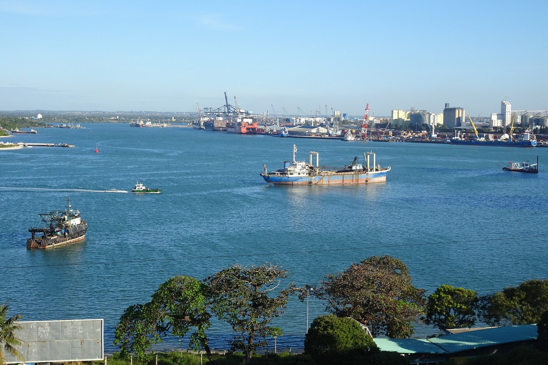 Ships in a busy port with city skyline