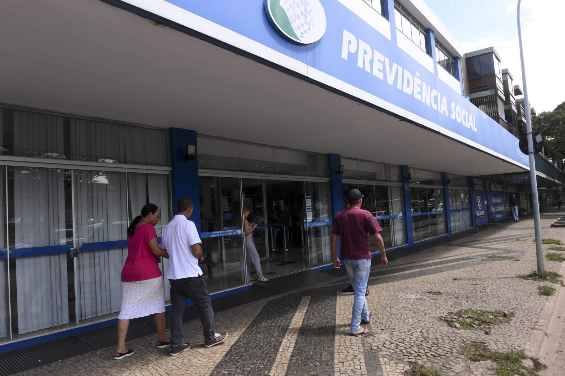 People outside a Previdencia Social (INSS) office in Brazil