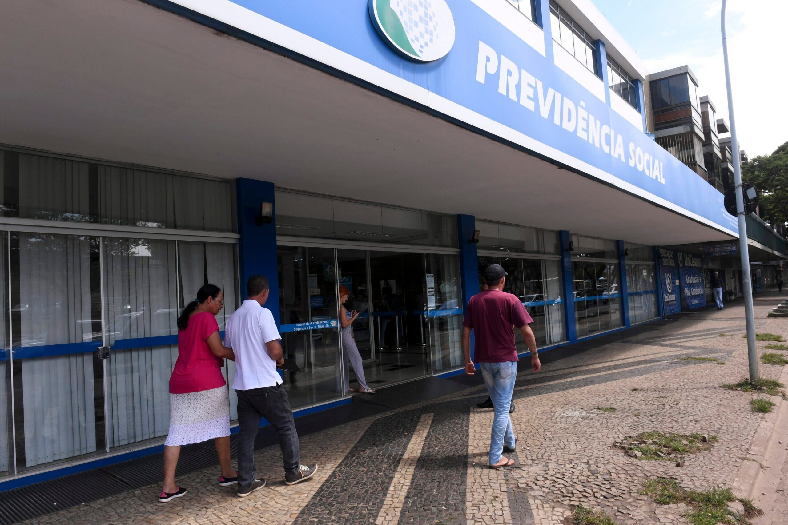 People outside a Previdencia Social (INSS) office in Brazil