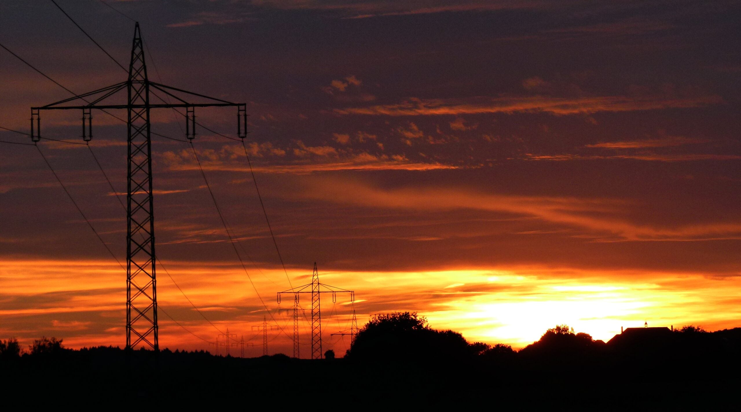 High-voltage electricity transmission towers at dusk.