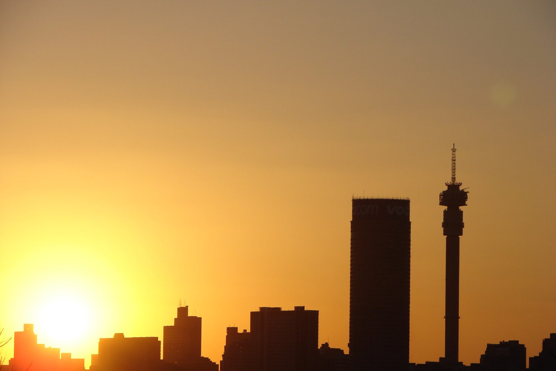 South African municipalities funding freeze — Johannesburg skyline at sunset
