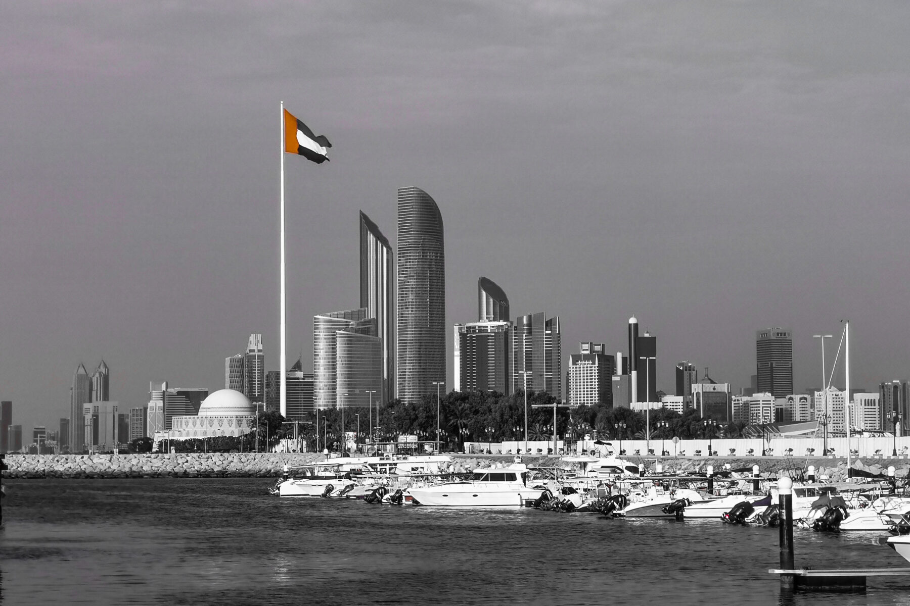 Abu Dhabi skyline with the UAE flag, home of sovereign investor Mubadala Capital