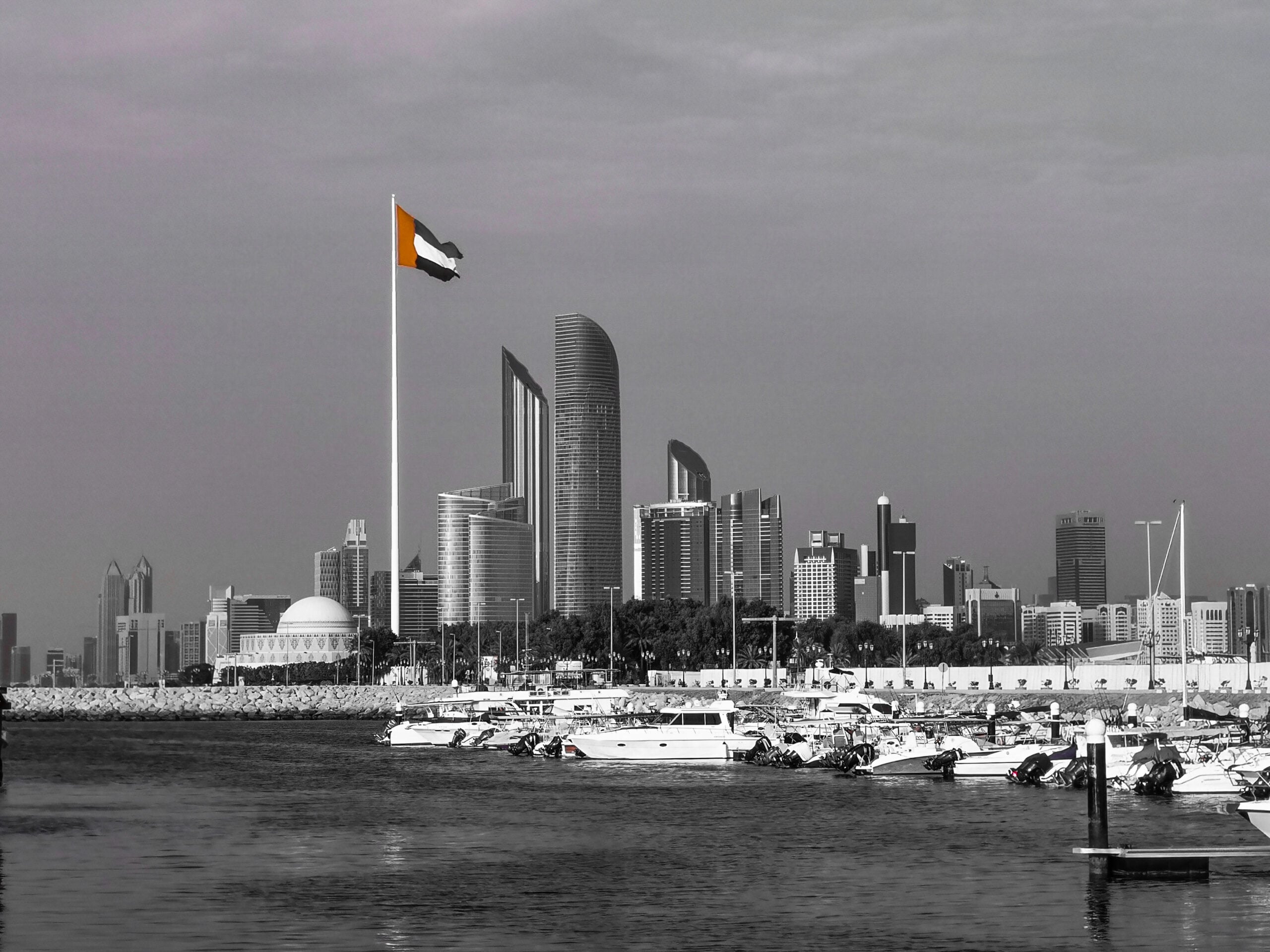 Abu Dhabi skyline with the UAE flag, home of sovereign investor Mubadala Capital