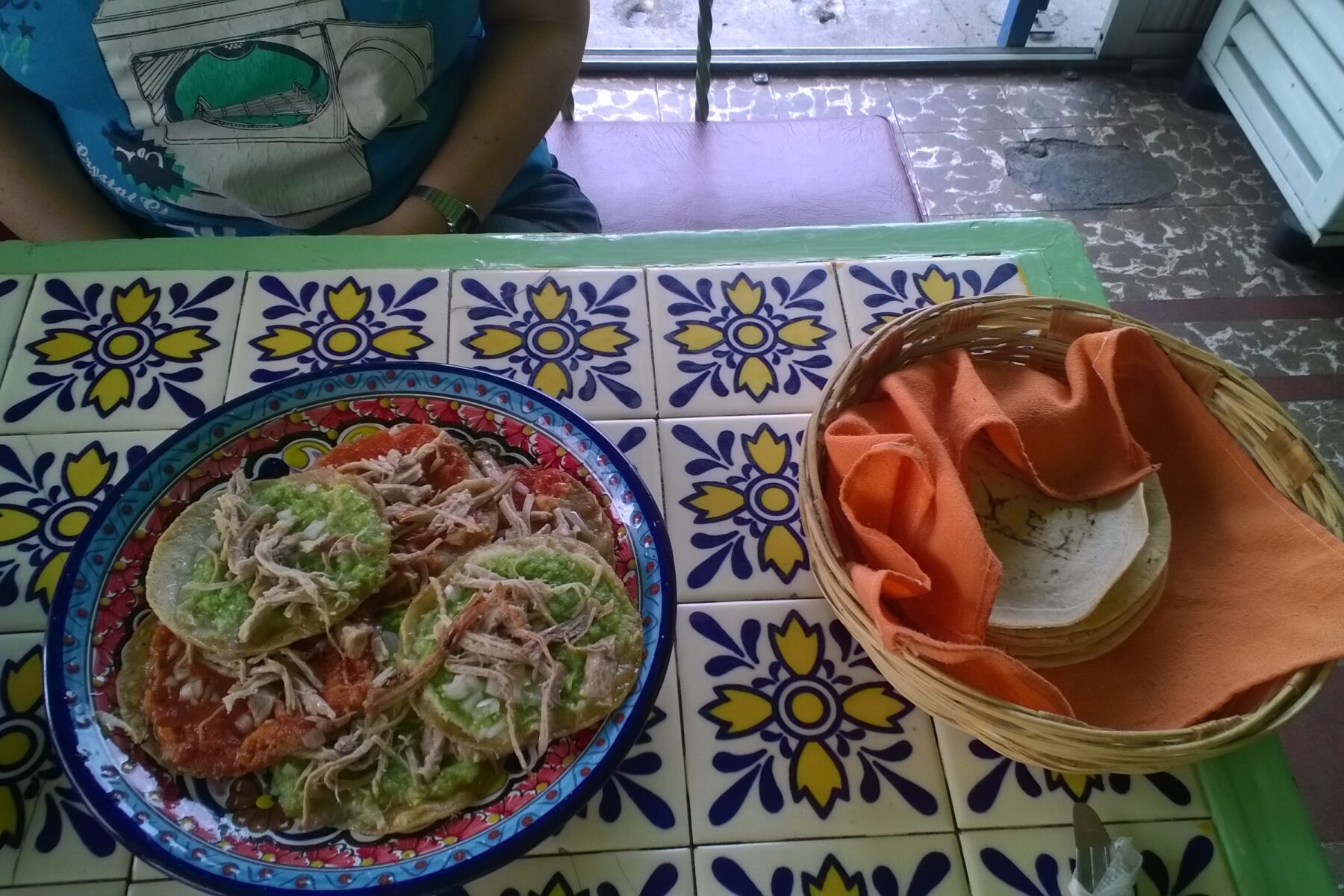 Mexican food on a table with decorative tiles