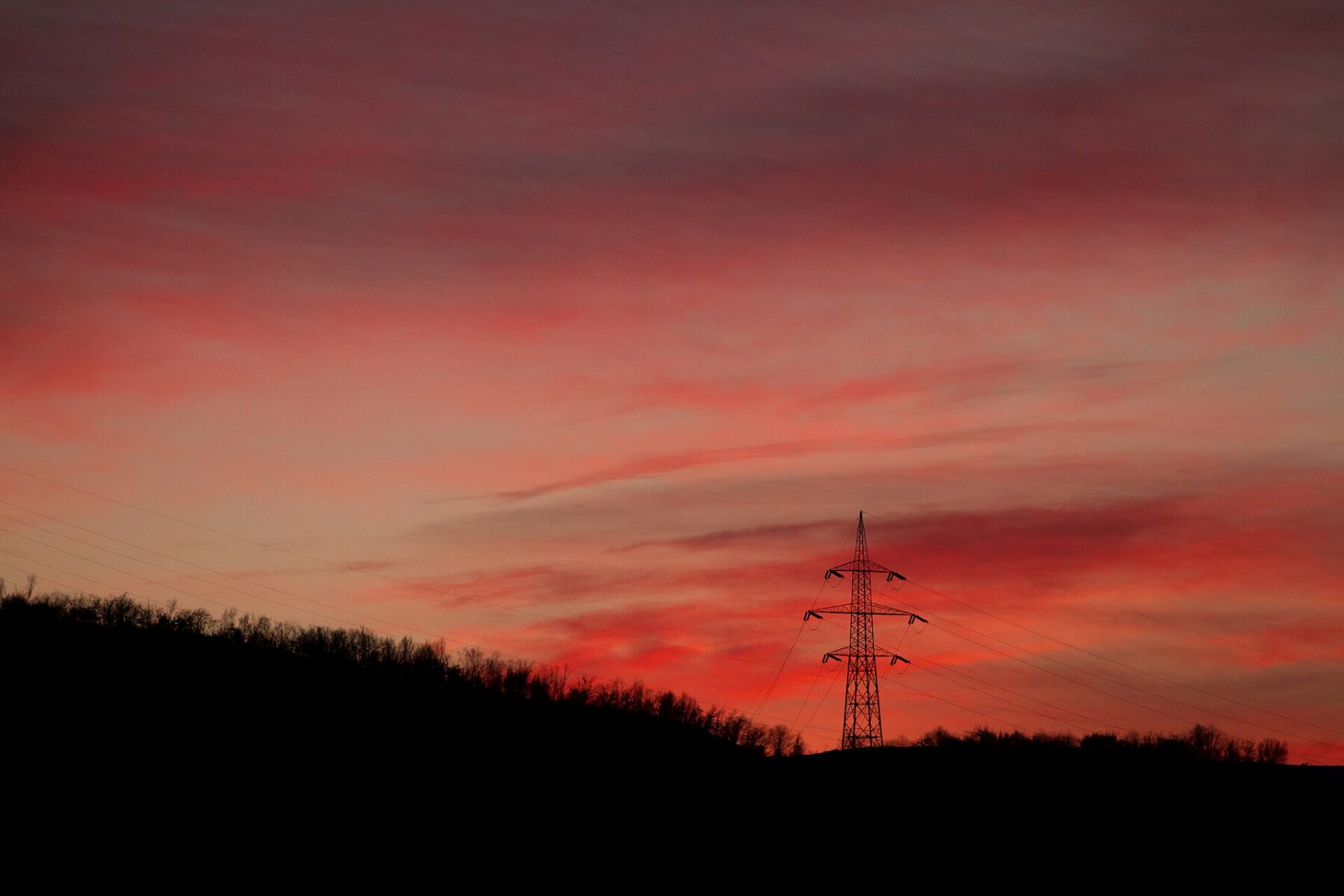 Electricity transmission tower at dusk, Colombia blackout risk