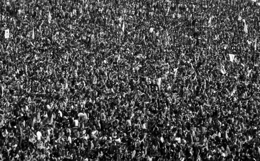 Large crowd of people, possibly at a concert or event