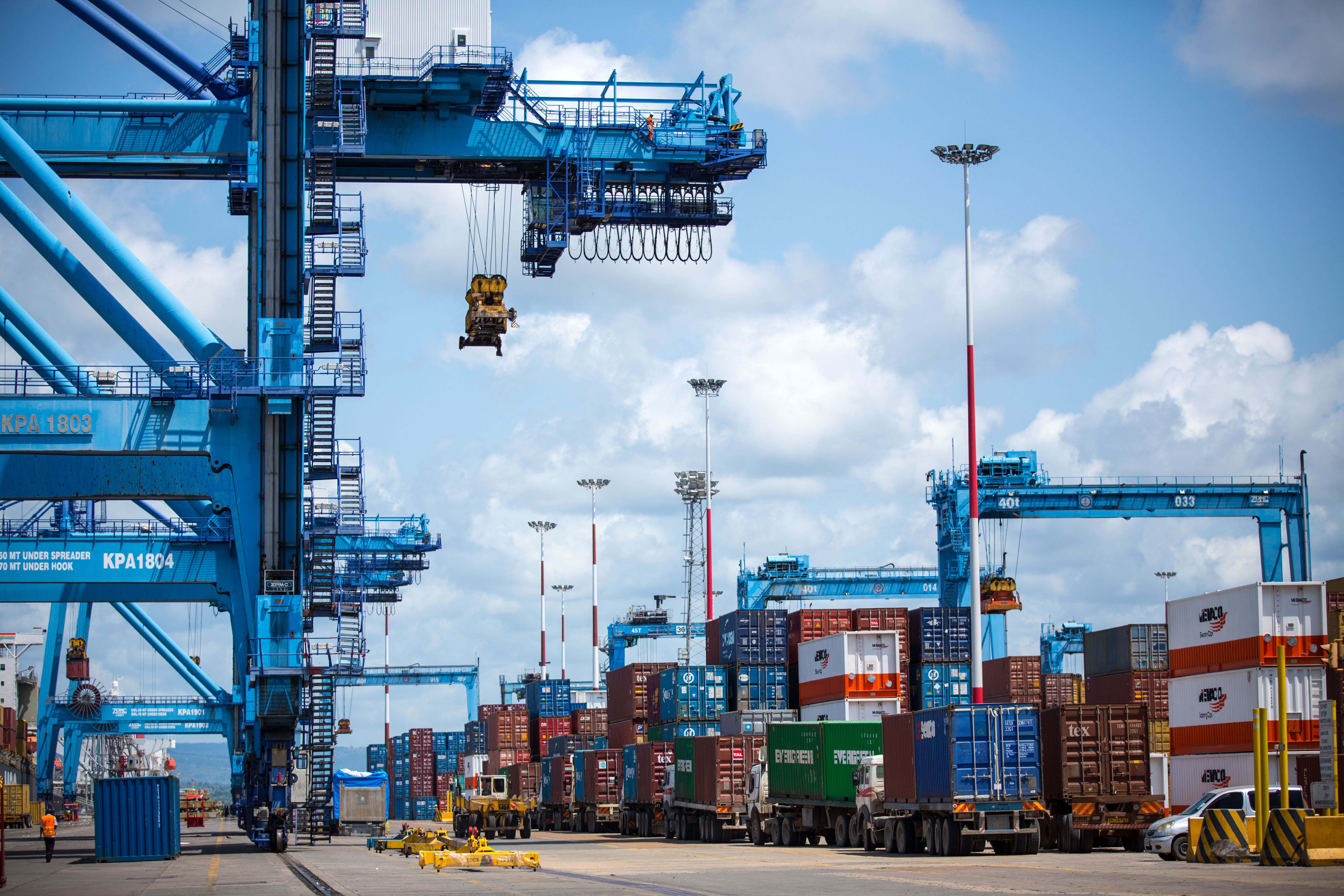Kenya customs benchmark - container trucks and cranes at the port of Mombasa