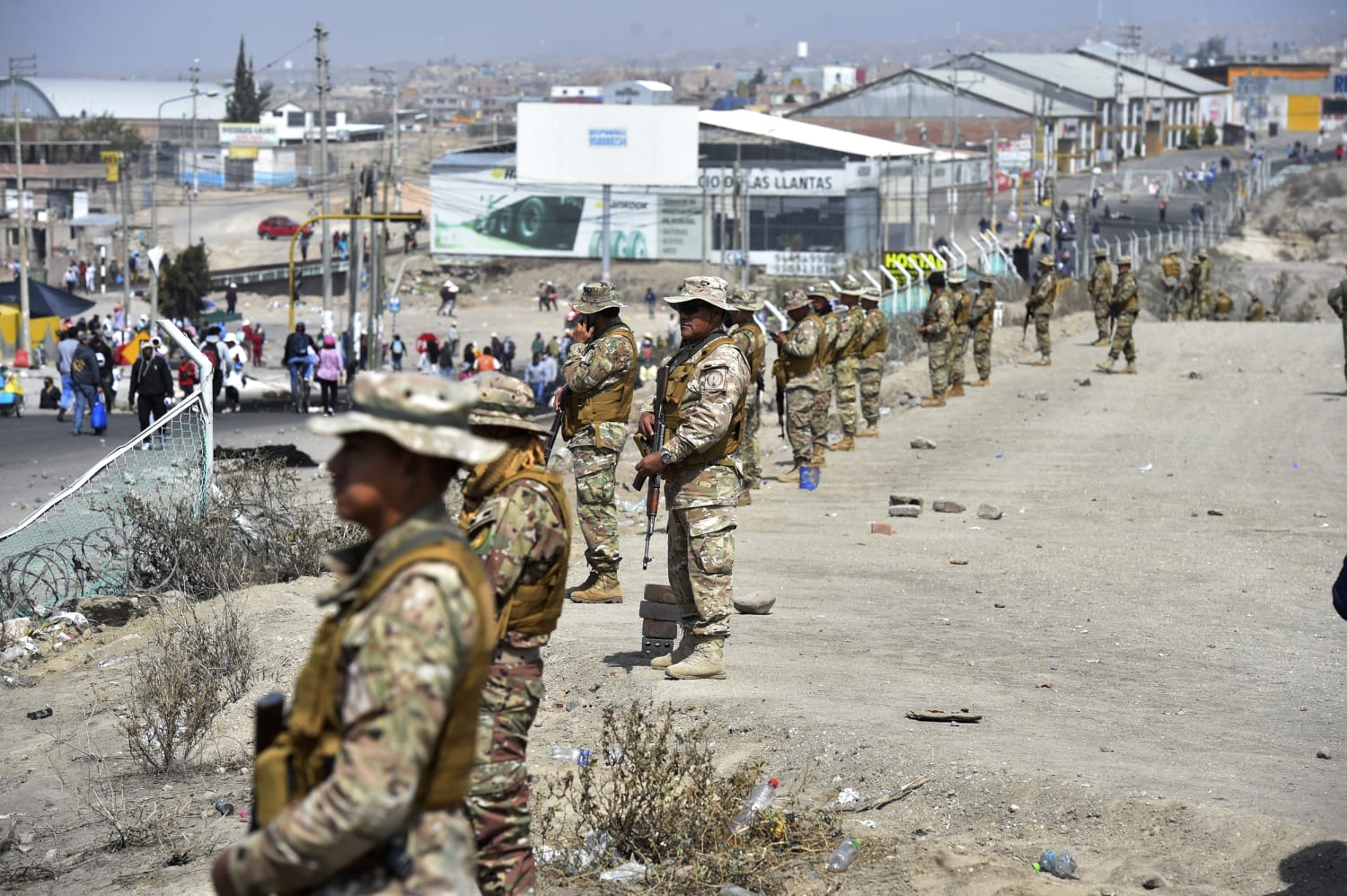 Peruvian National Police officers displaying seized firearms at a press conference in Callao