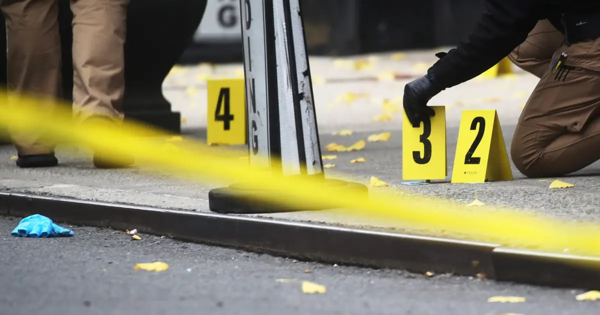 Evidence markers and police tape at a crime scene, illustrating Colima safety data