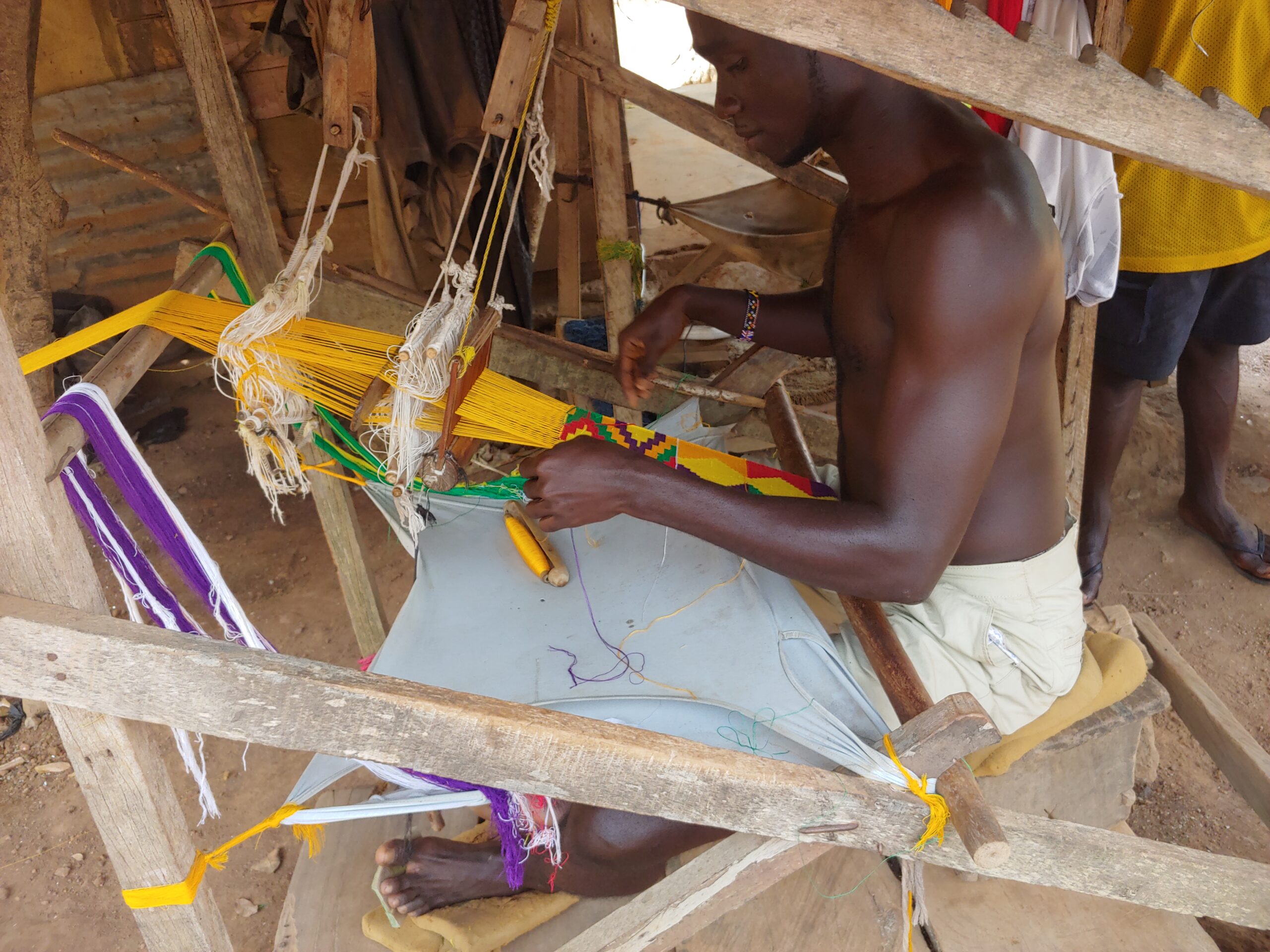 A weaver at a loom in Bonwire, home of the kente geographical indication