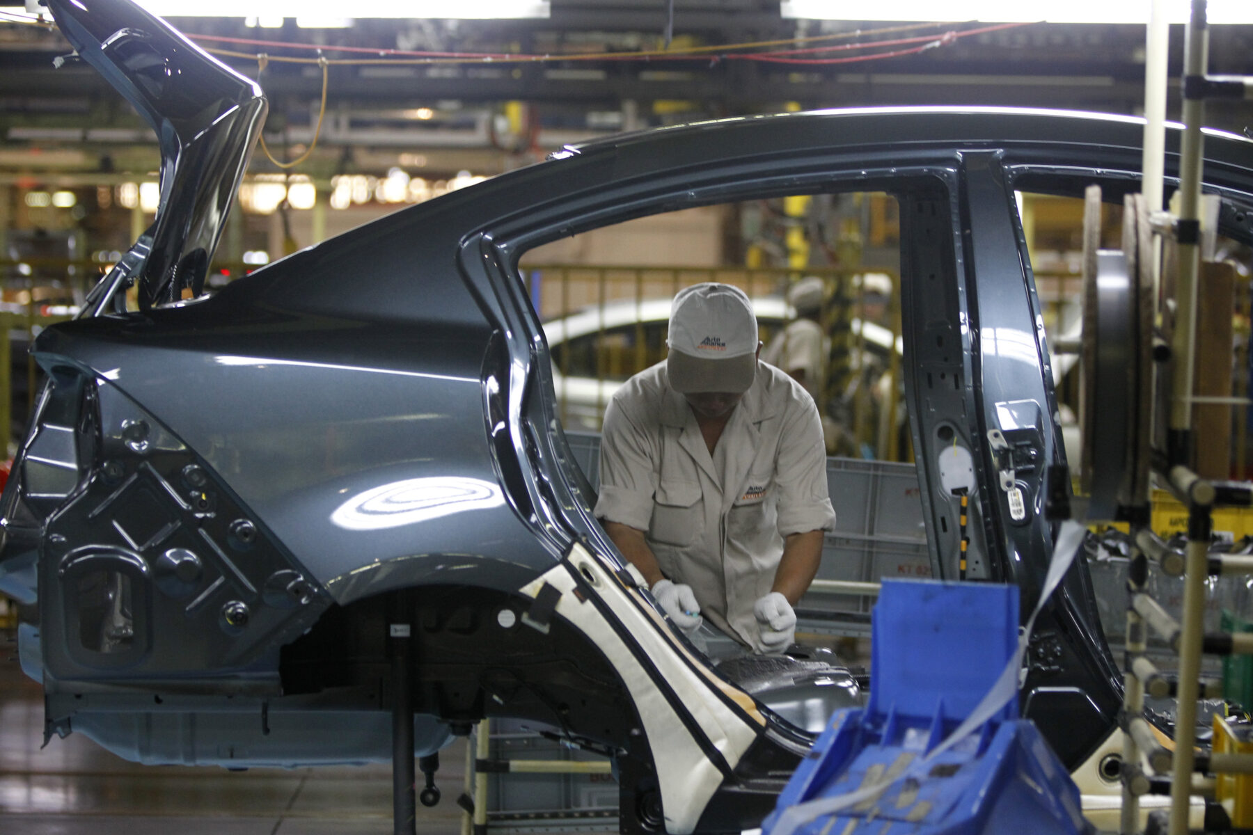 An employee works at an assembly line in AutoAlliance Thailand, a Ford and Mazda joint venture plant, located in Rayong province