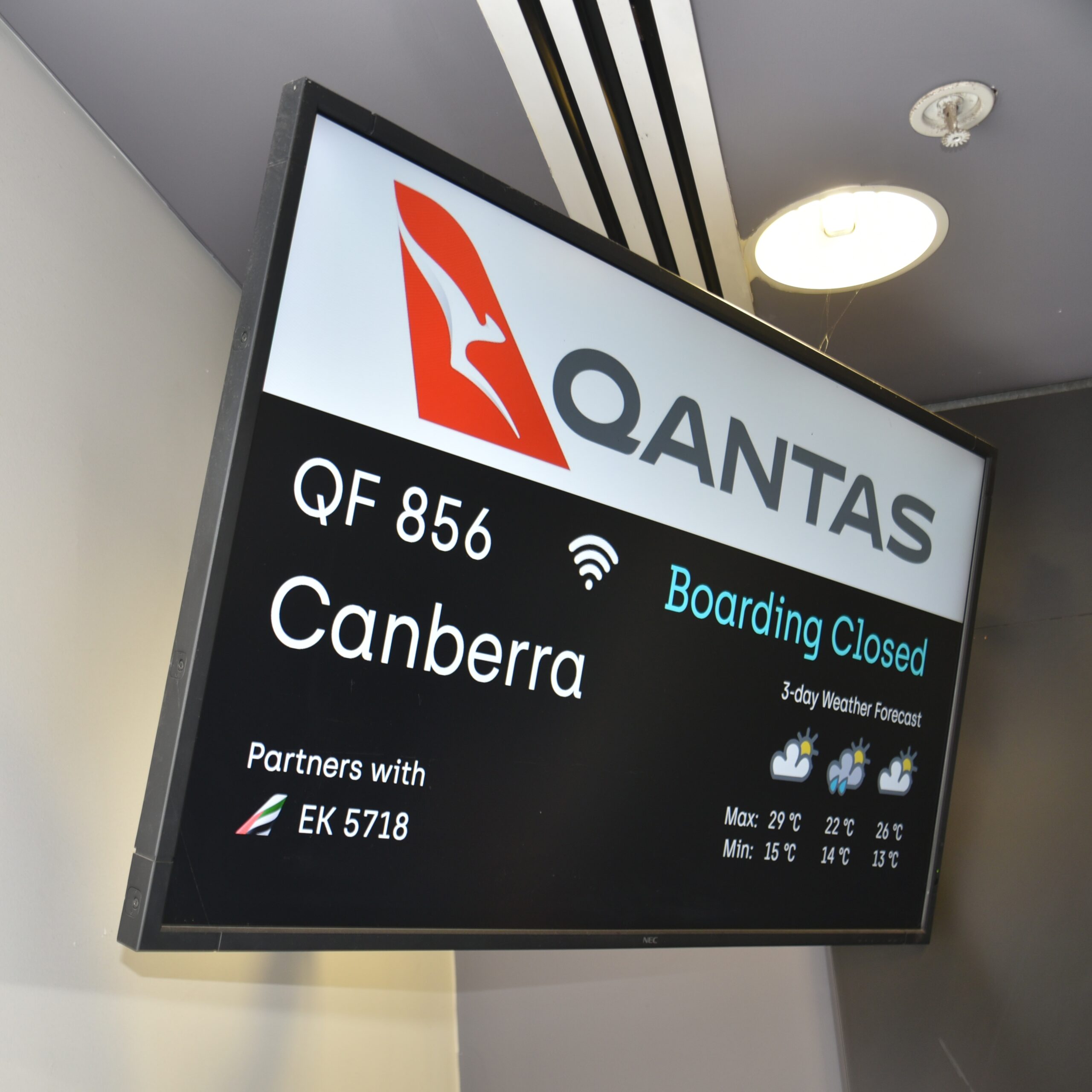 A flight departure board showing delays and cancellations