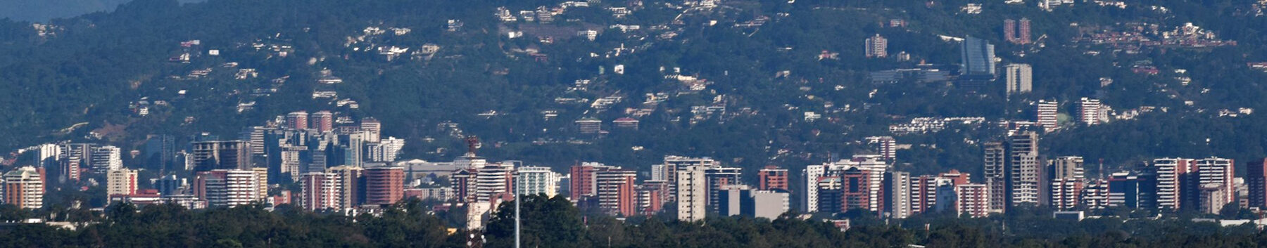 Cityscape with buildings and hills in the background