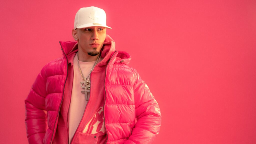 Man in pink puffer jacket and white cap