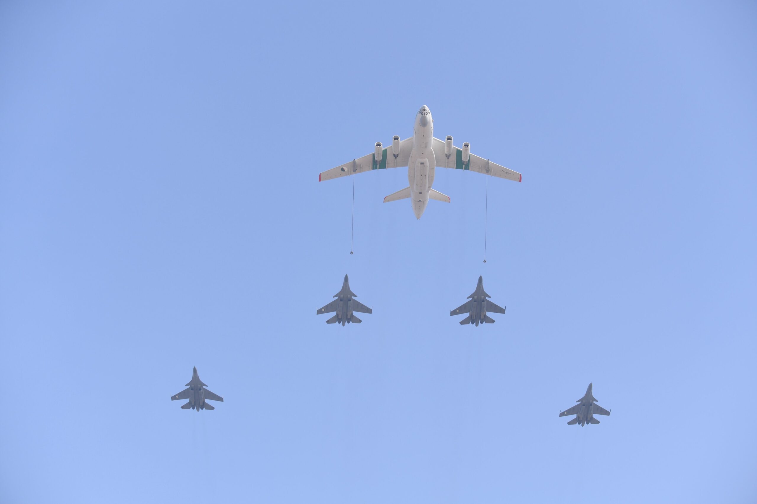 Algerian fighter jets refuelling in flight behind a tanker aircraft