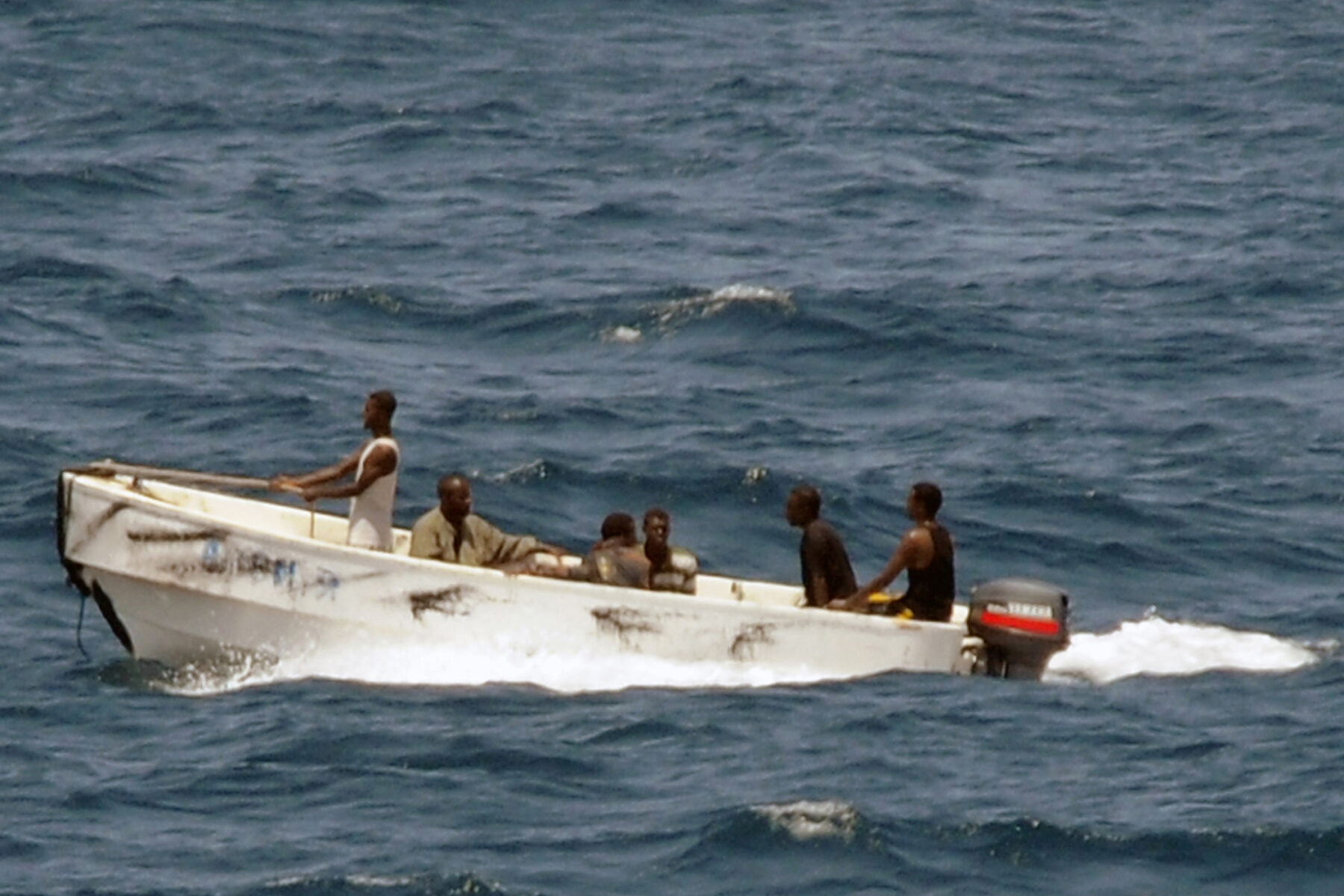 Pirates leave a hijacked merchant ship off Somalia under US Navy observation