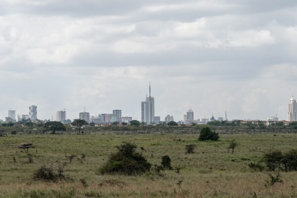 The Nairobi skyline seen from the savannah of Nairobi National Park, Kenya.
