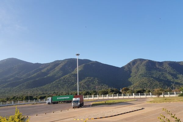 Cargo trucks at the Namanga border post between Kenya and Tanzania, with Ol-Donyo Orok mountain behind.