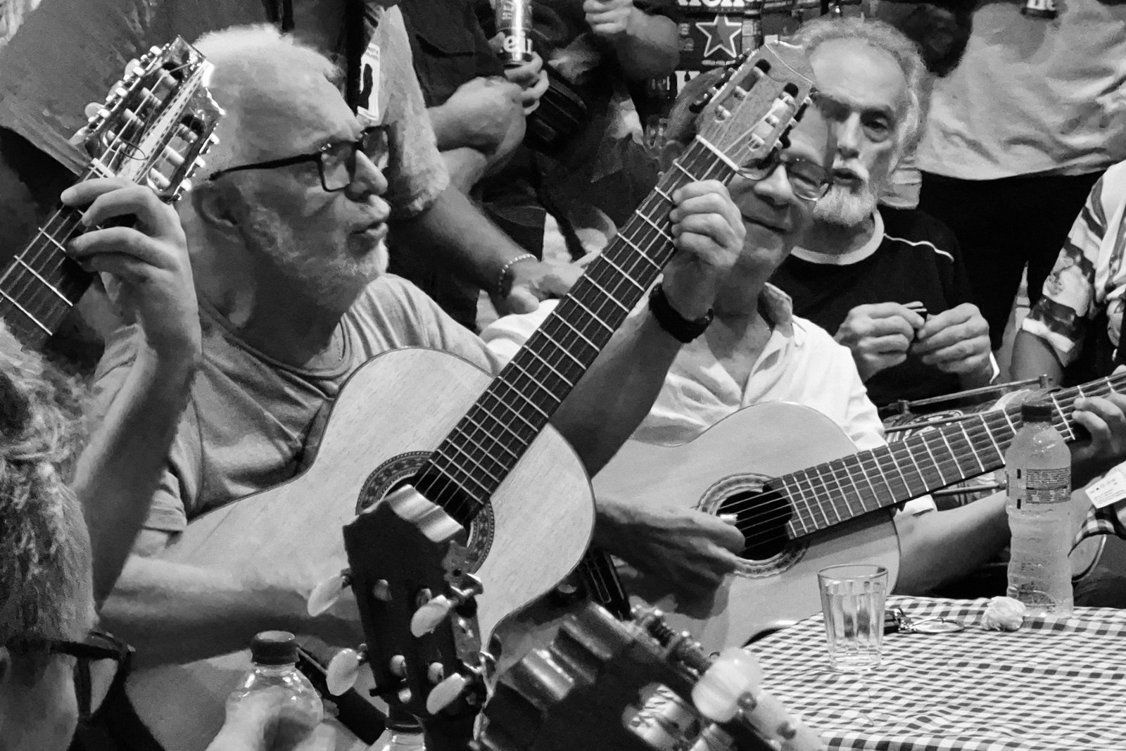 Musicians playing guitars in a crowded samba roda at Bip Bip in Copacabana
