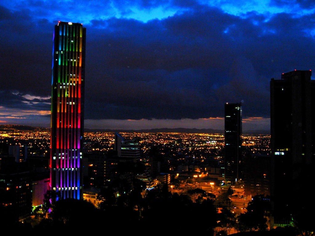 The Colpatria tower lit in colours above the Bogota skyline at night
