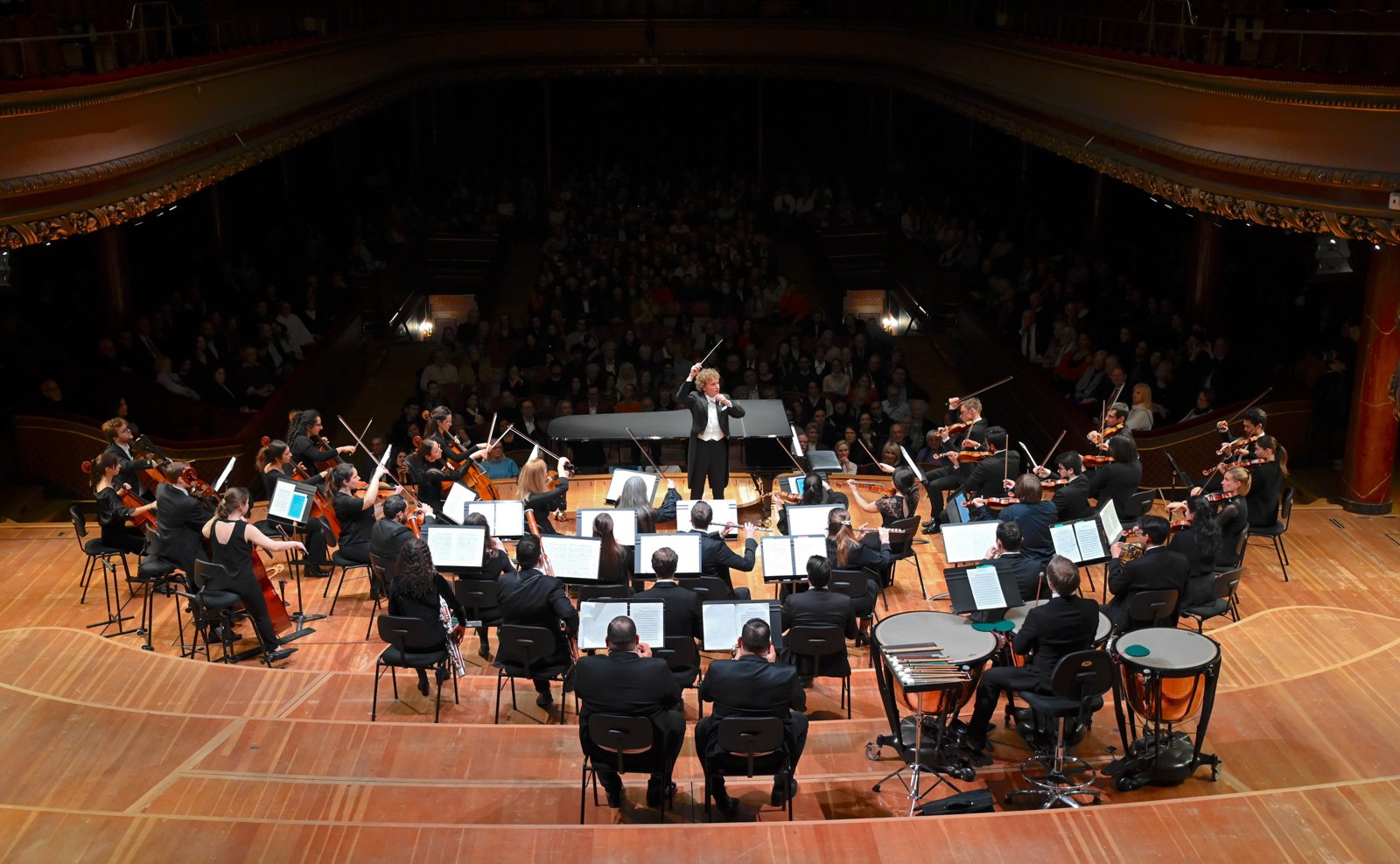 A symphony orchestra performing in a concert hall.
