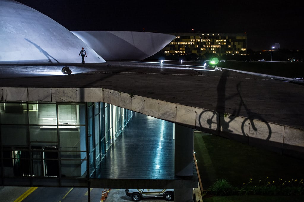 Brazil's National Congress building illuminated at night in Brasília.