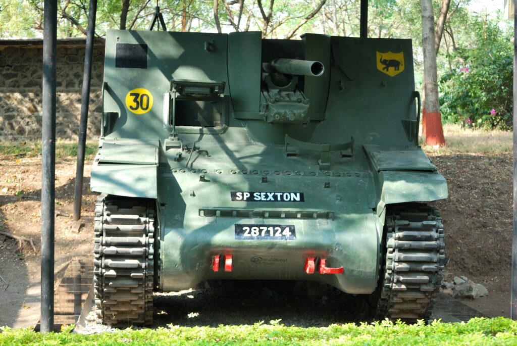 A restored armoured tank displayed at a military museum, similar to the vehicles shown at Bravura Park in Santa Catarina.