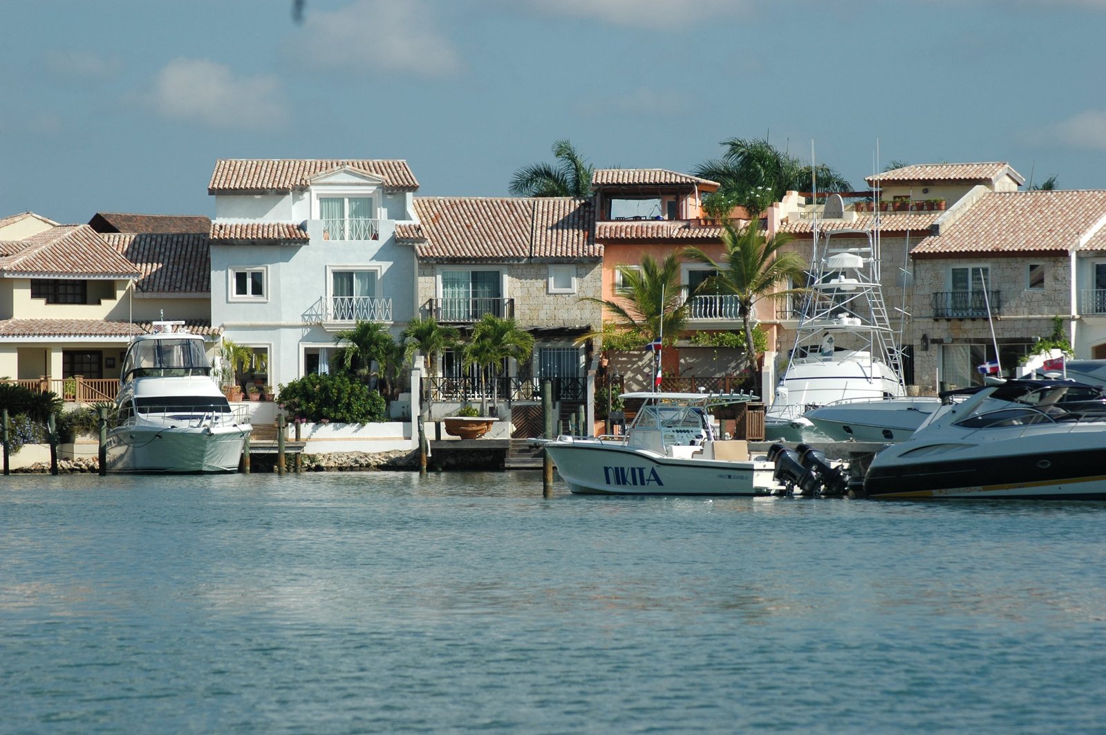 Yachts and boats moored at Casa de Campo marina in La Romana, waterfront villas behind