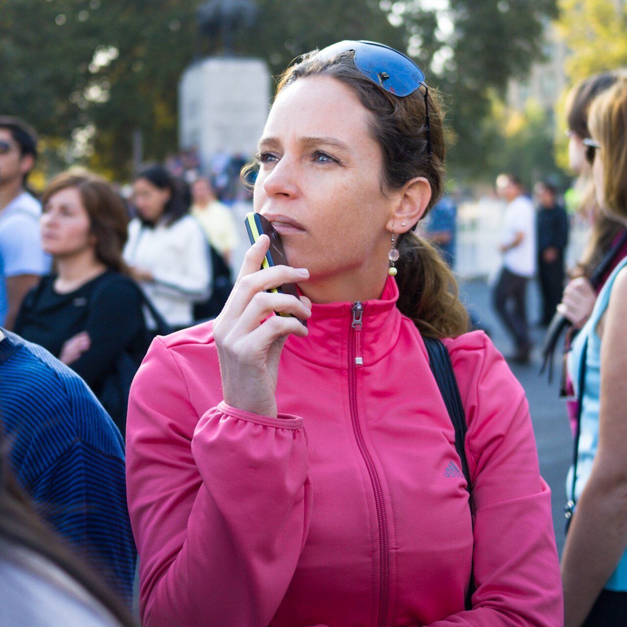 A woman using a mobile phone in Santiago, where Chile SIM registration now applies to prepaid lines