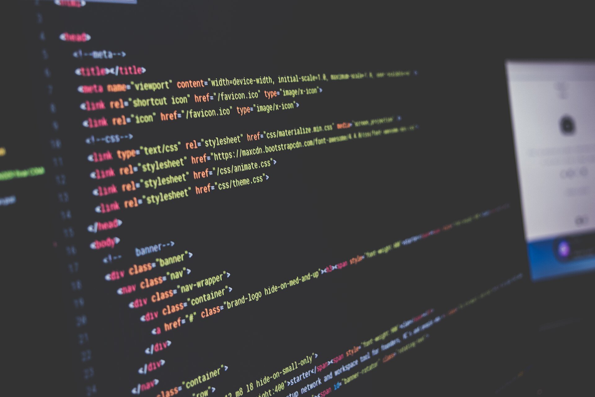 Cl0p data theft claim - lines of website source code on a dark computer monitor