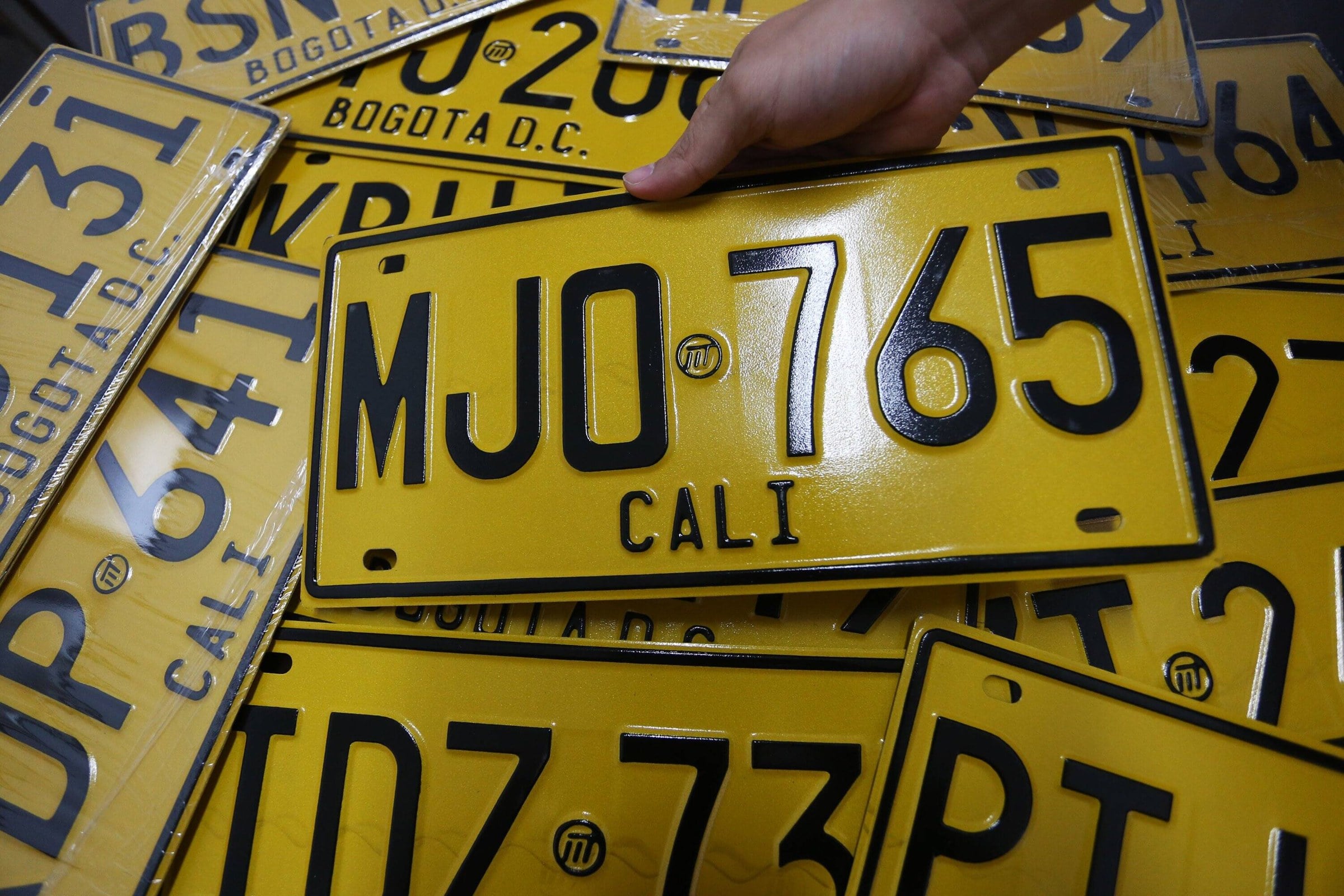 A stack of newly issued Colombian vehicle licence plates for Bogota and Cali