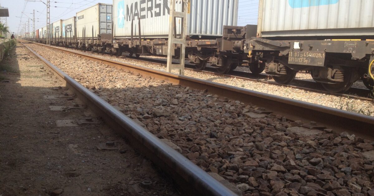 A freight train carries cargo along an African rail line.