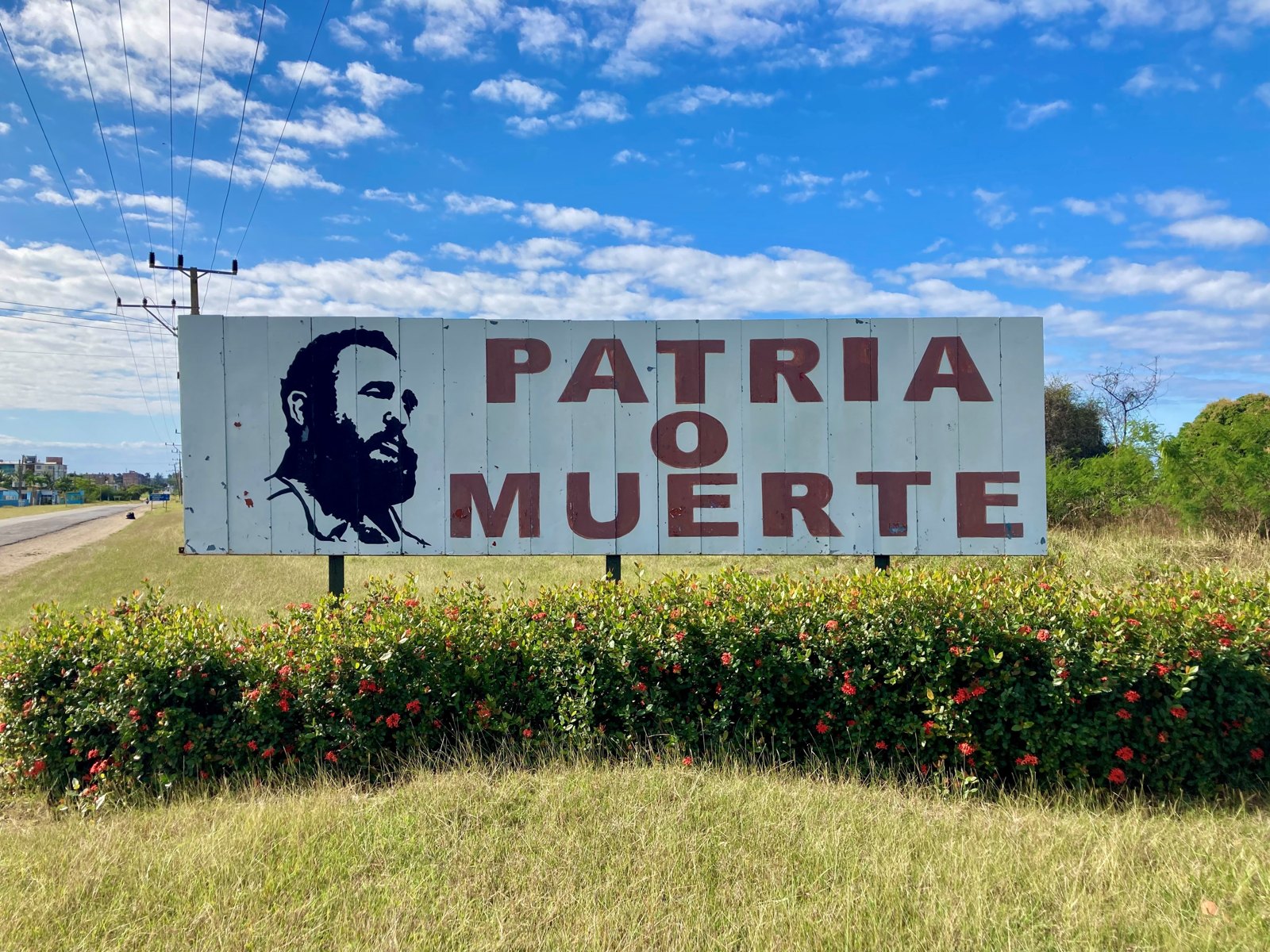 A billboard in Cuba bearing Fidel Castro’s image and the slogan “Patria o Muerte”.