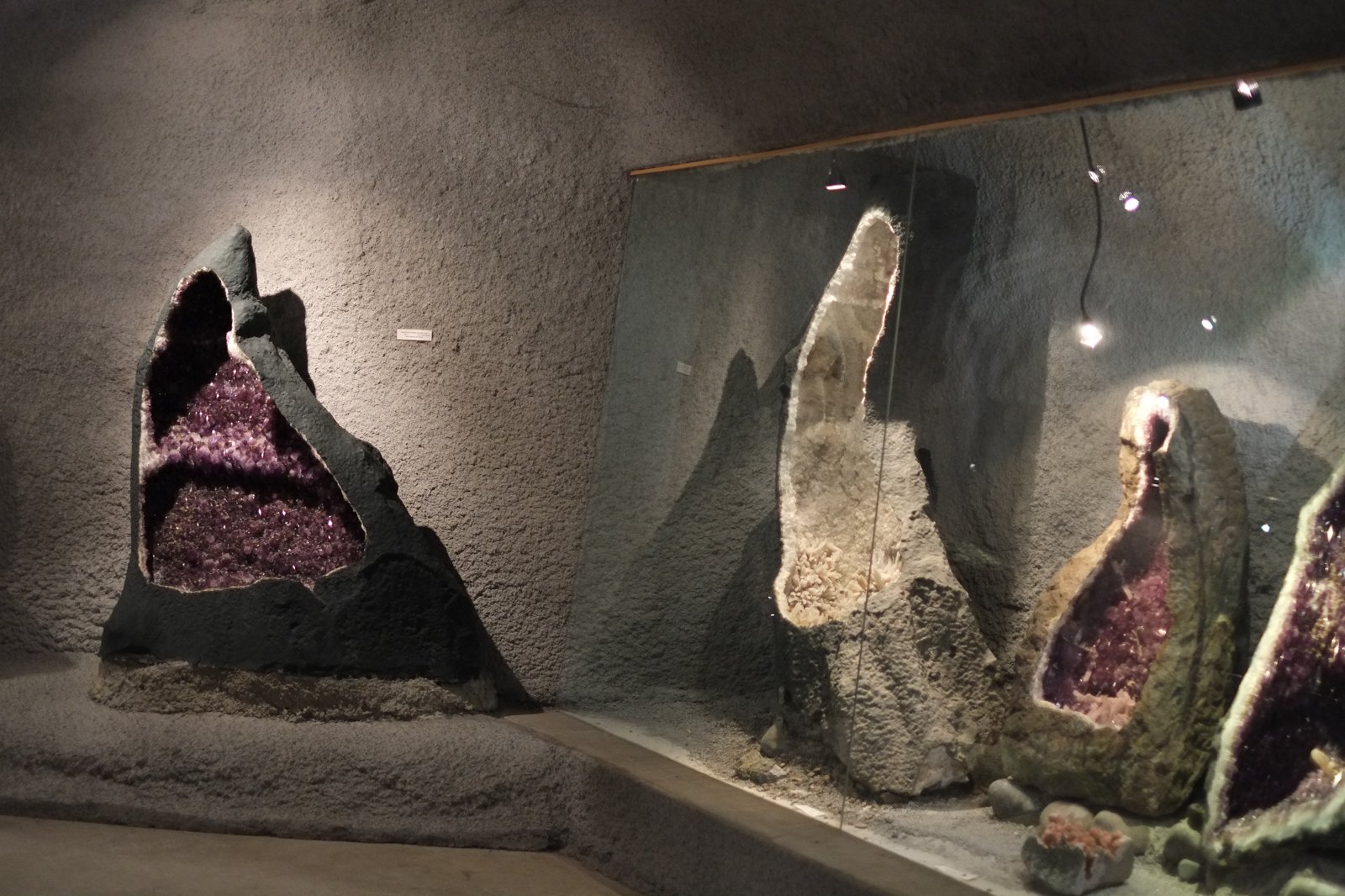 Large amethyst geode formations on display.