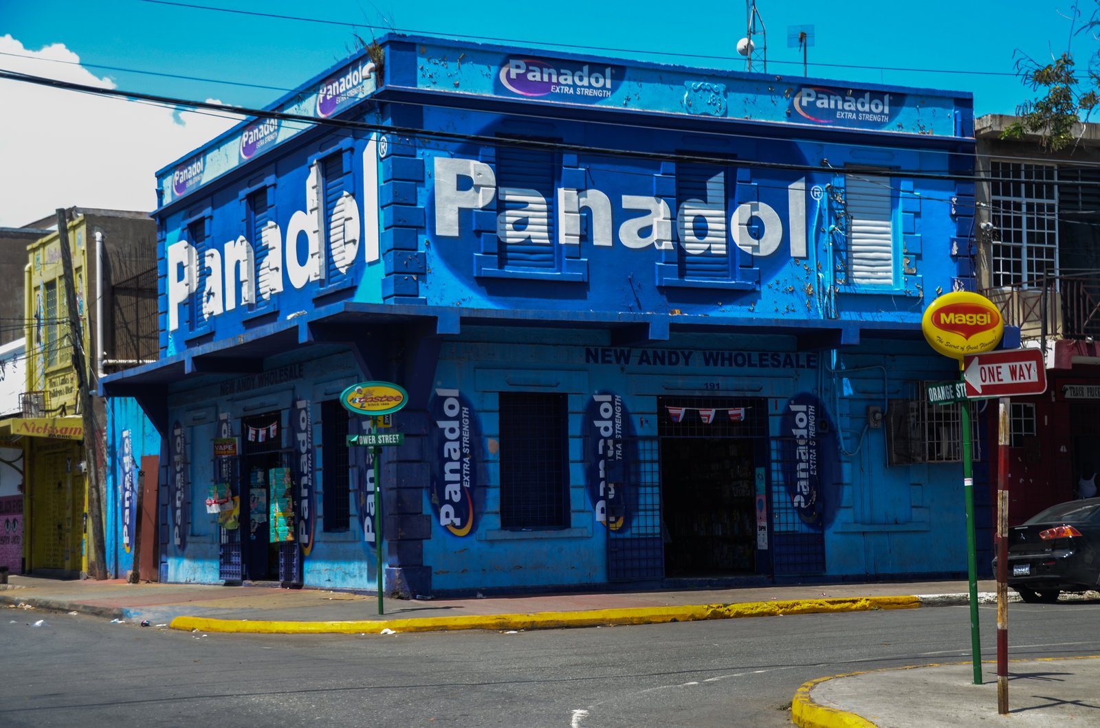 A brightly painted shop building on Orange Street in downtown Kingston, Jamaica