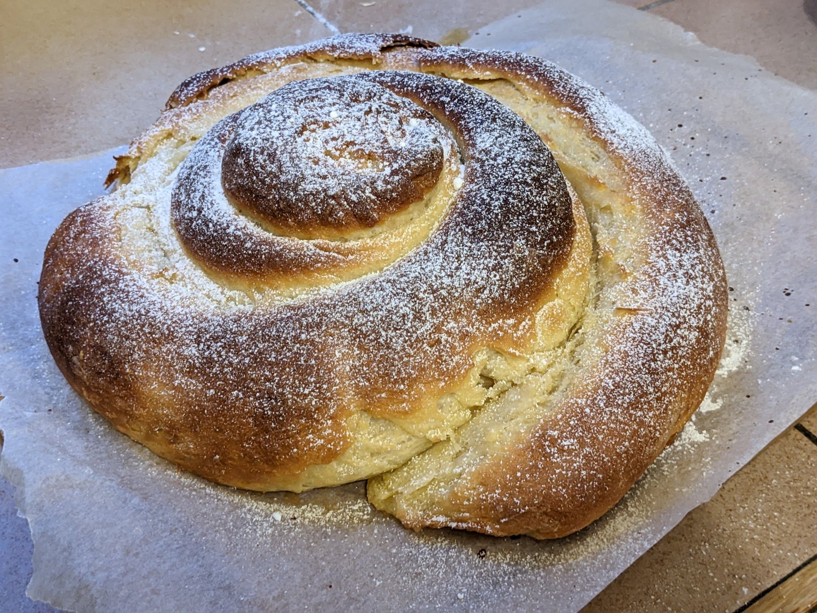 A traditional ensaimada pastry dusted with sugar.
