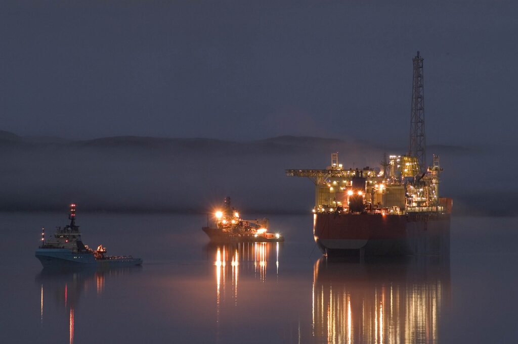 Oil rig and support vessels at night