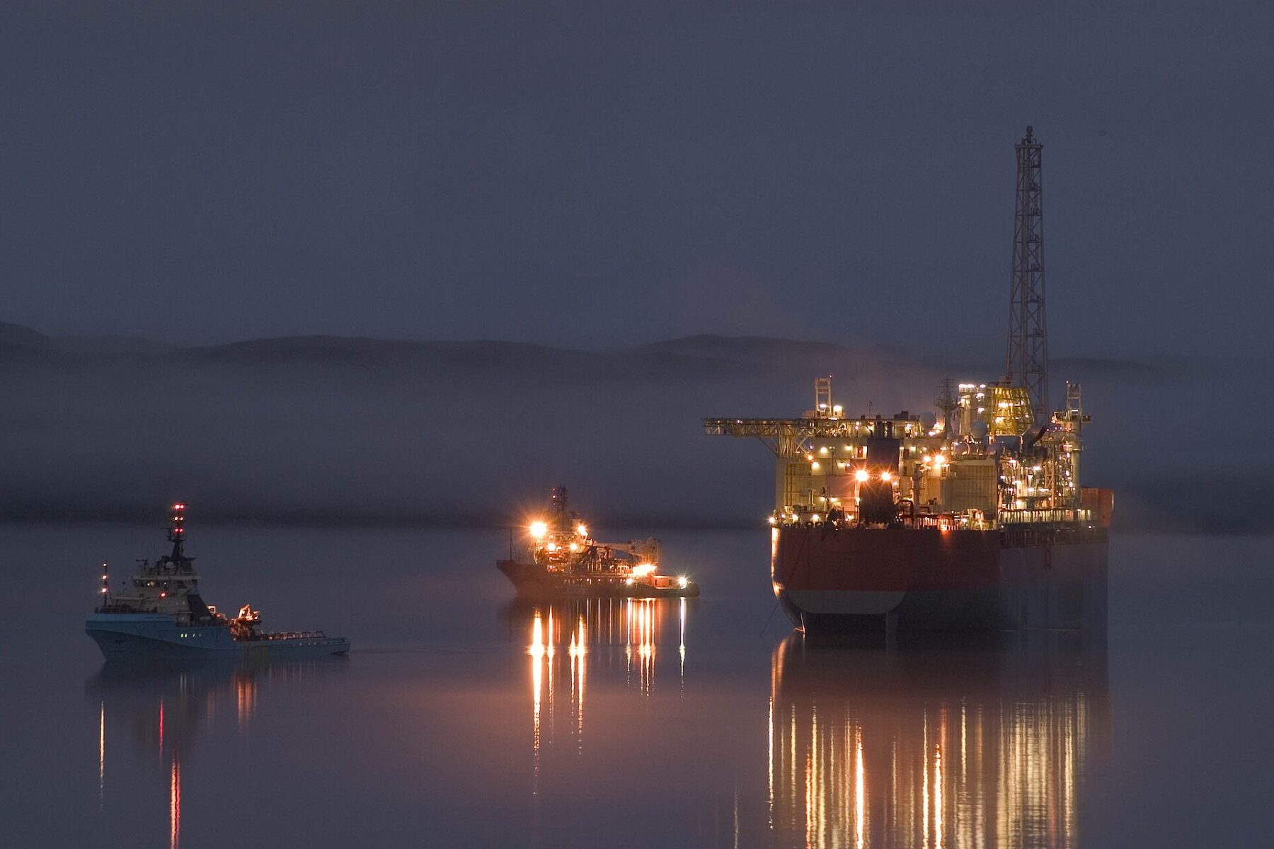 Oil rig and support vessels at night