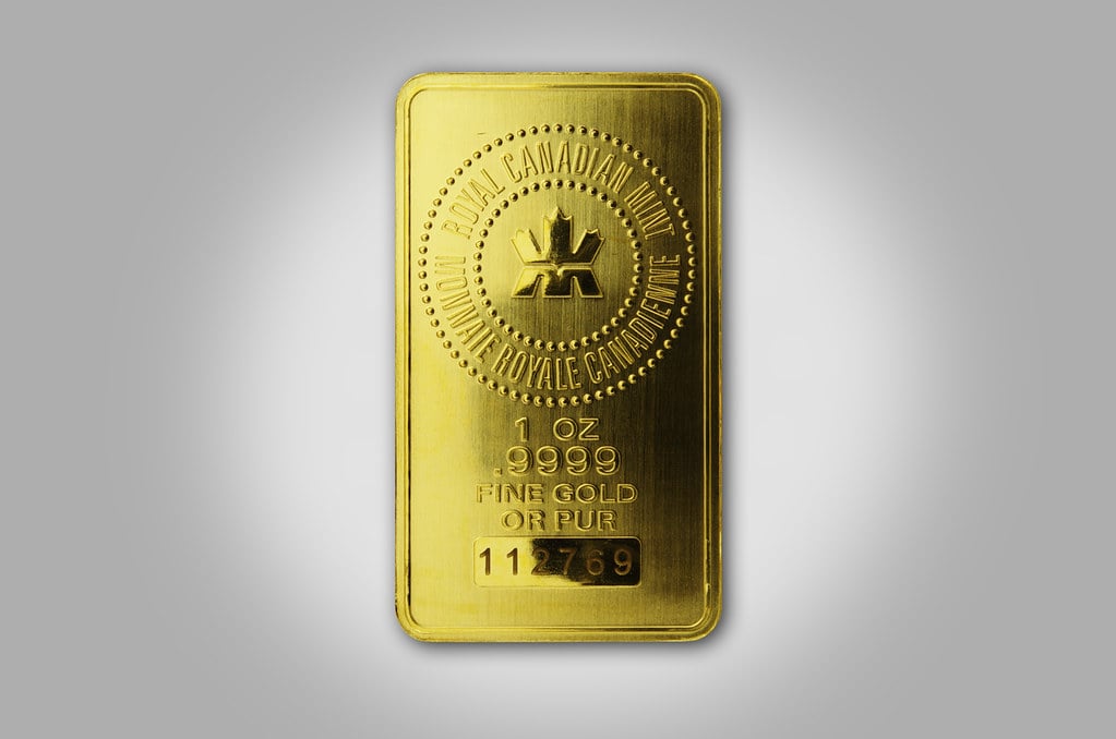 A one-ounce fine gold bar on a grey background, illustrating the gold and silver market wrap