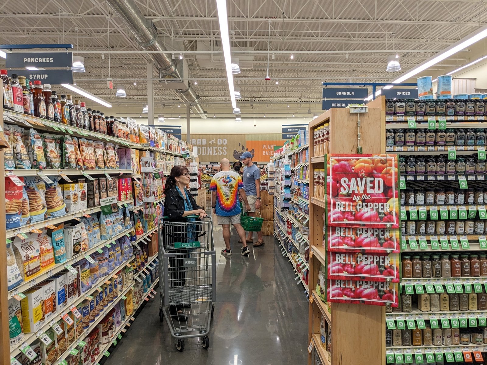 Shoppers in a supermarket aisle.