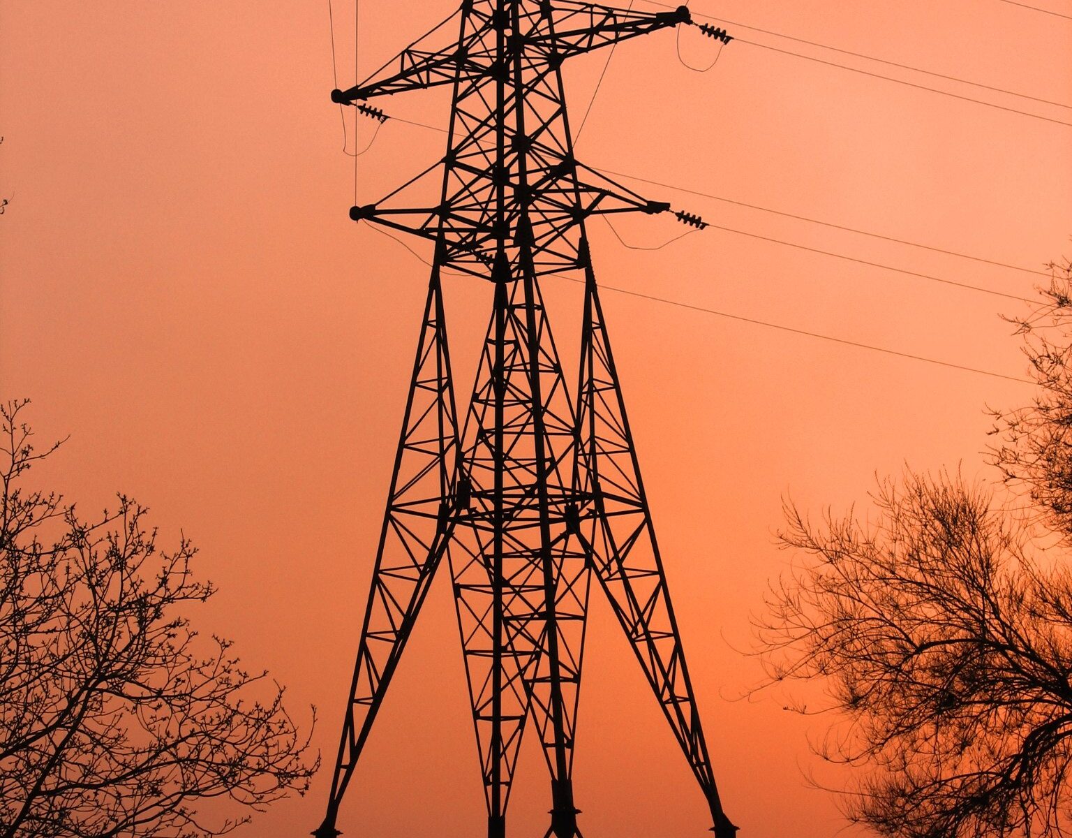 An electricity transmission tower at dusk.