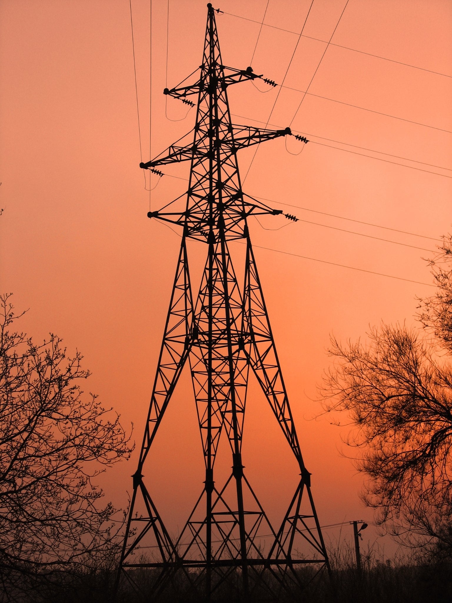 An electricity transmission tower at dusk.