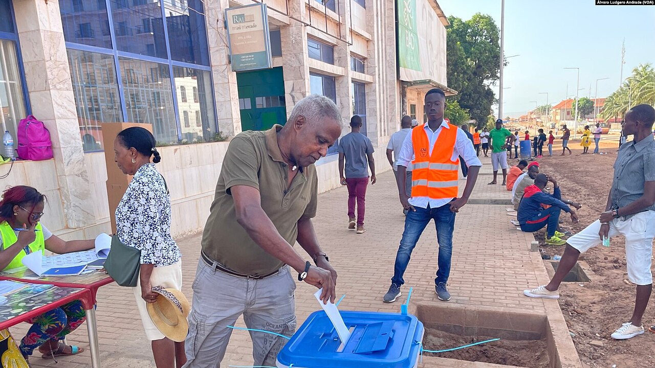 A voter places his ballot in the box at a polling station in Bissau