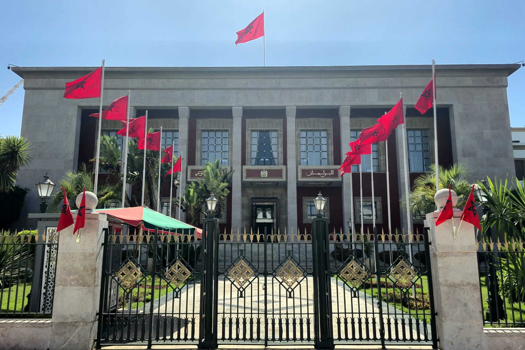 A government building in Rabat with Moroccan flags along the railings