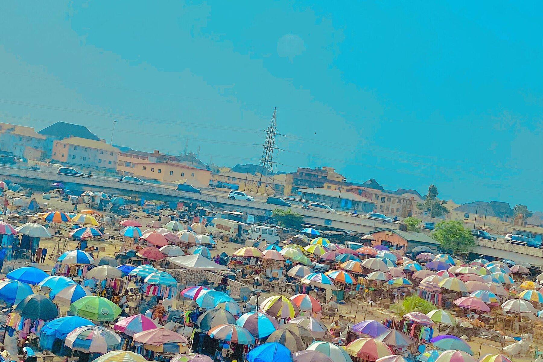 Jumia IFC raise - traders under umbrella stalls at an open-air market in Nigeria