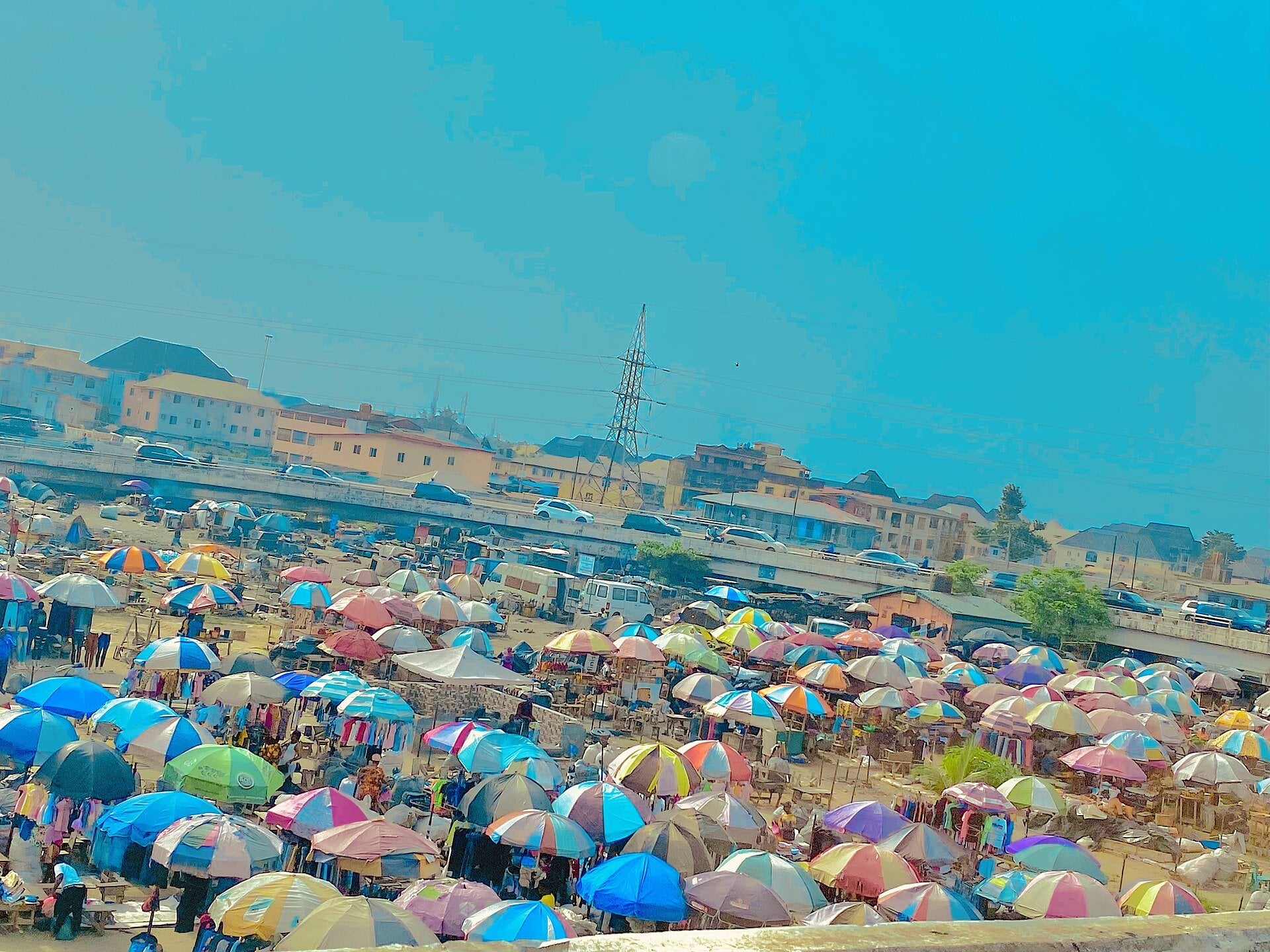 Jumia IFC raise - traders under umbrella stalls at an open-air market in Nigeria