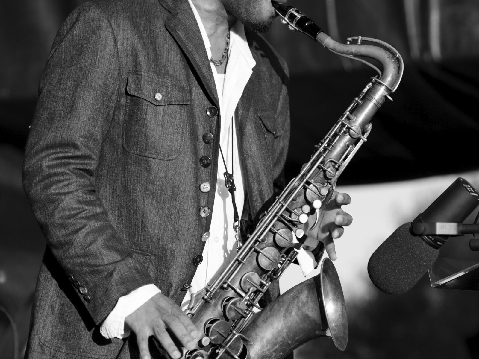 A saxophonist performs on stage.