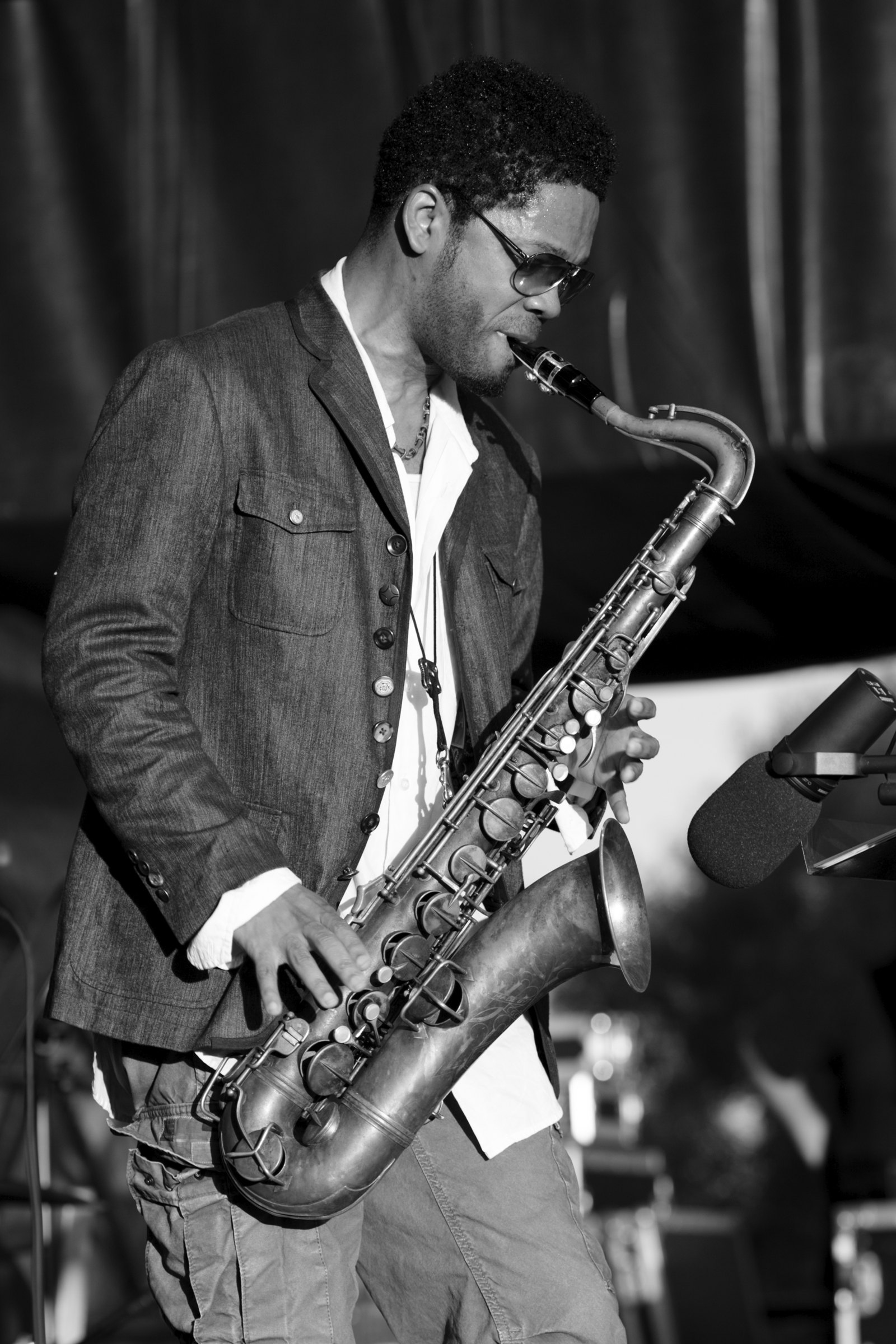 A saxophonist performs on stage.