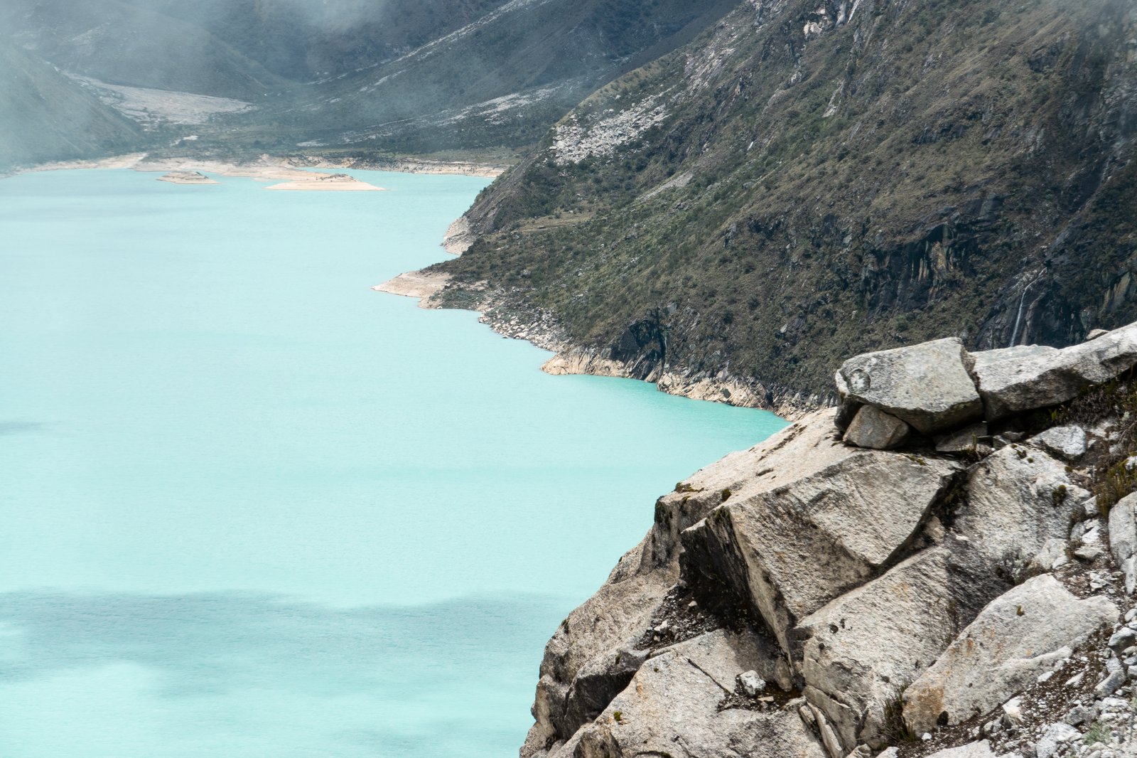 The turquoise glacial lake Laguna Parón below steep rock walls in Peru's Cordillera Blanca